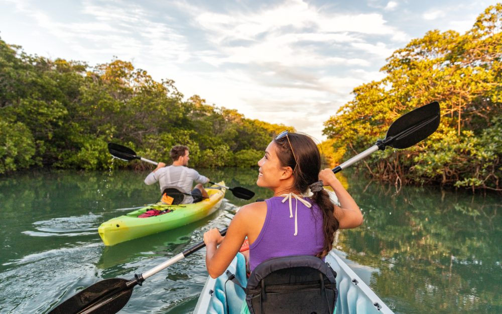 Man and Woman Kayaking Down River